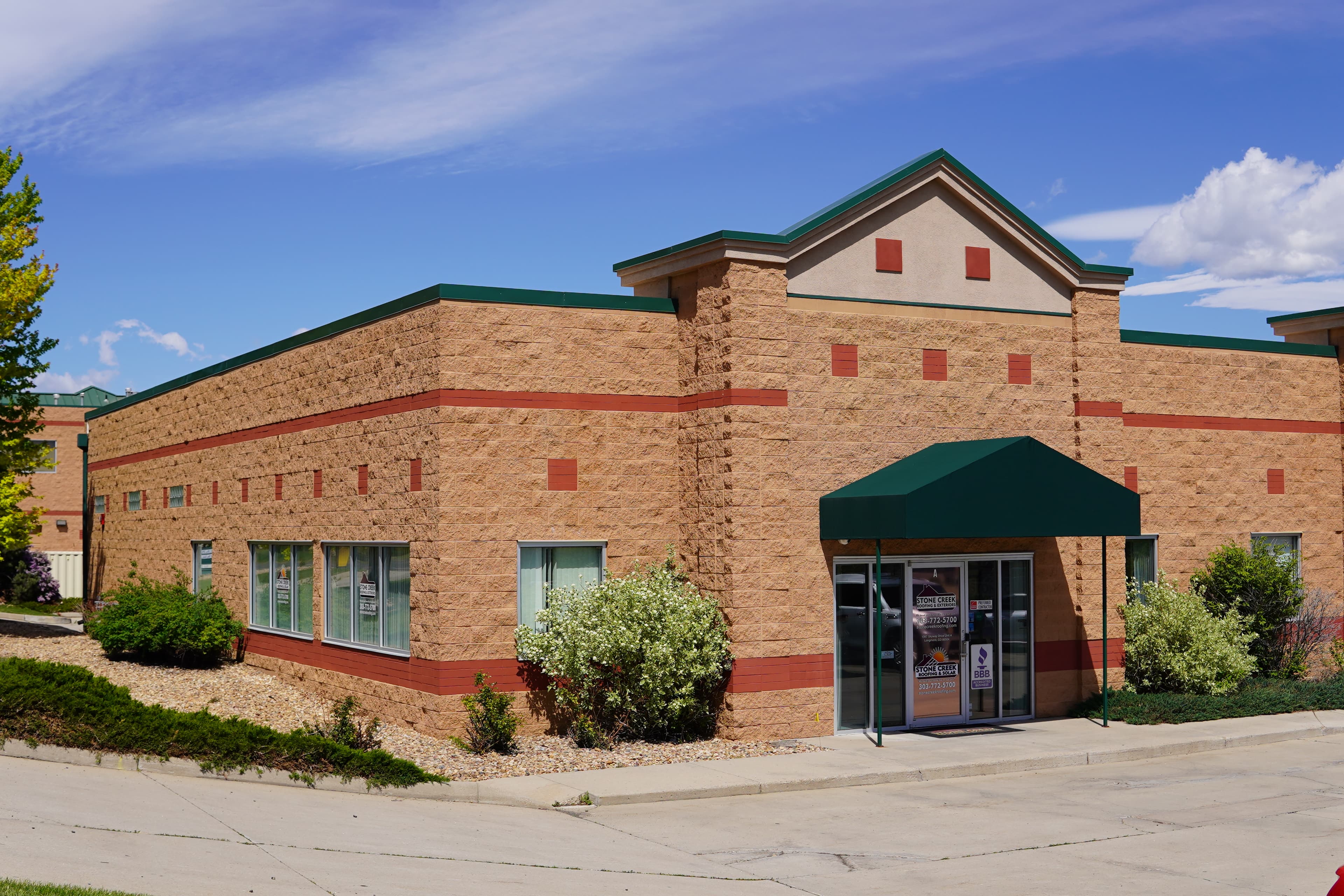Roofing team in front of front range mountains
